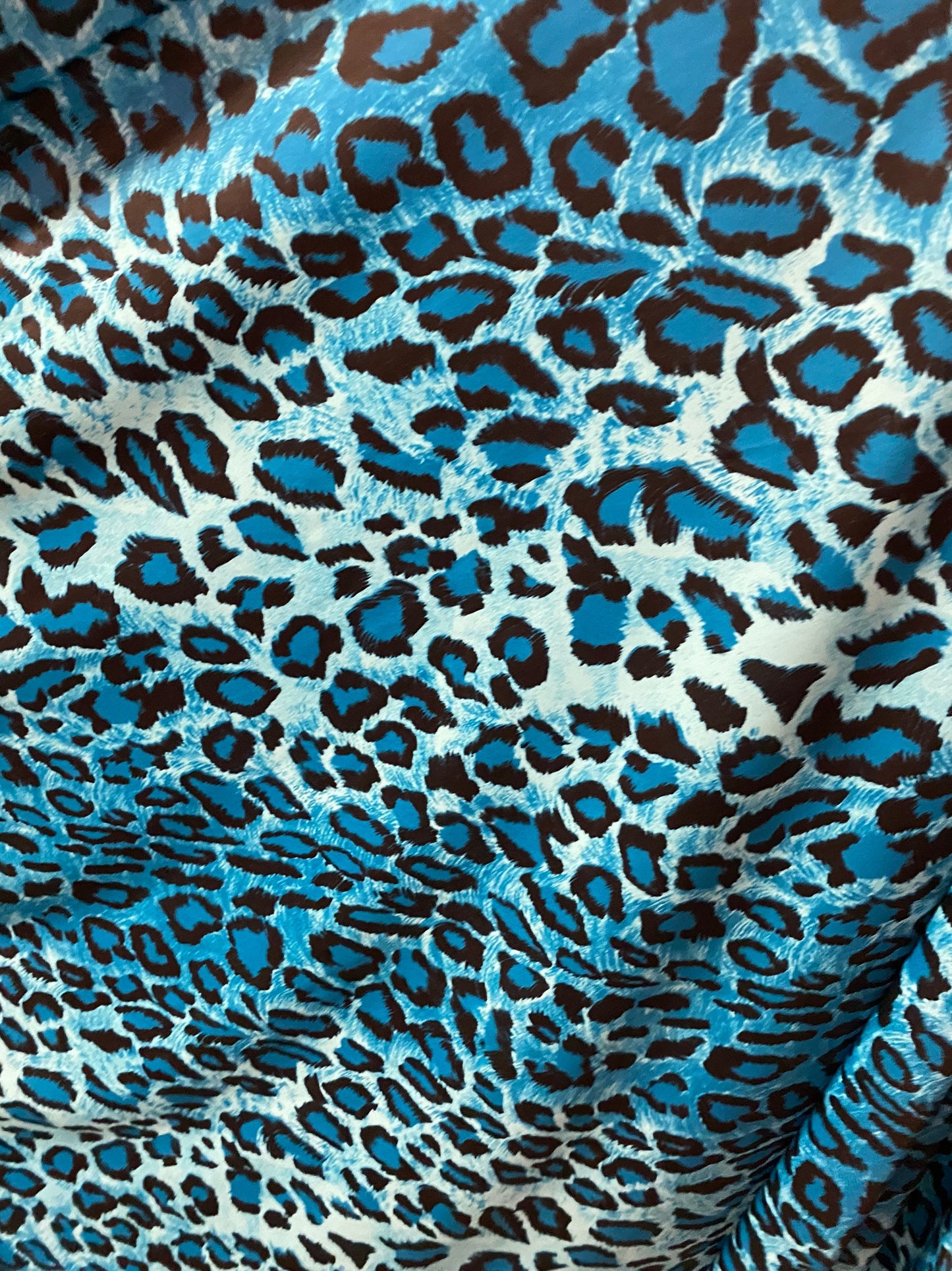 Exotic leopard design Teal/Blue/black print on nylon spandex 4-way stretch 58/60” Sold by the YD. Ships worldwide from Los Angeles Californi