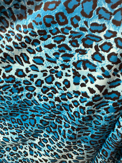 Exotic leopard design Teal/Blue/black print on nylon spandex 4-way stretch 58/60” Sold by the YD. Ships worldwide from Los Angeles Californi