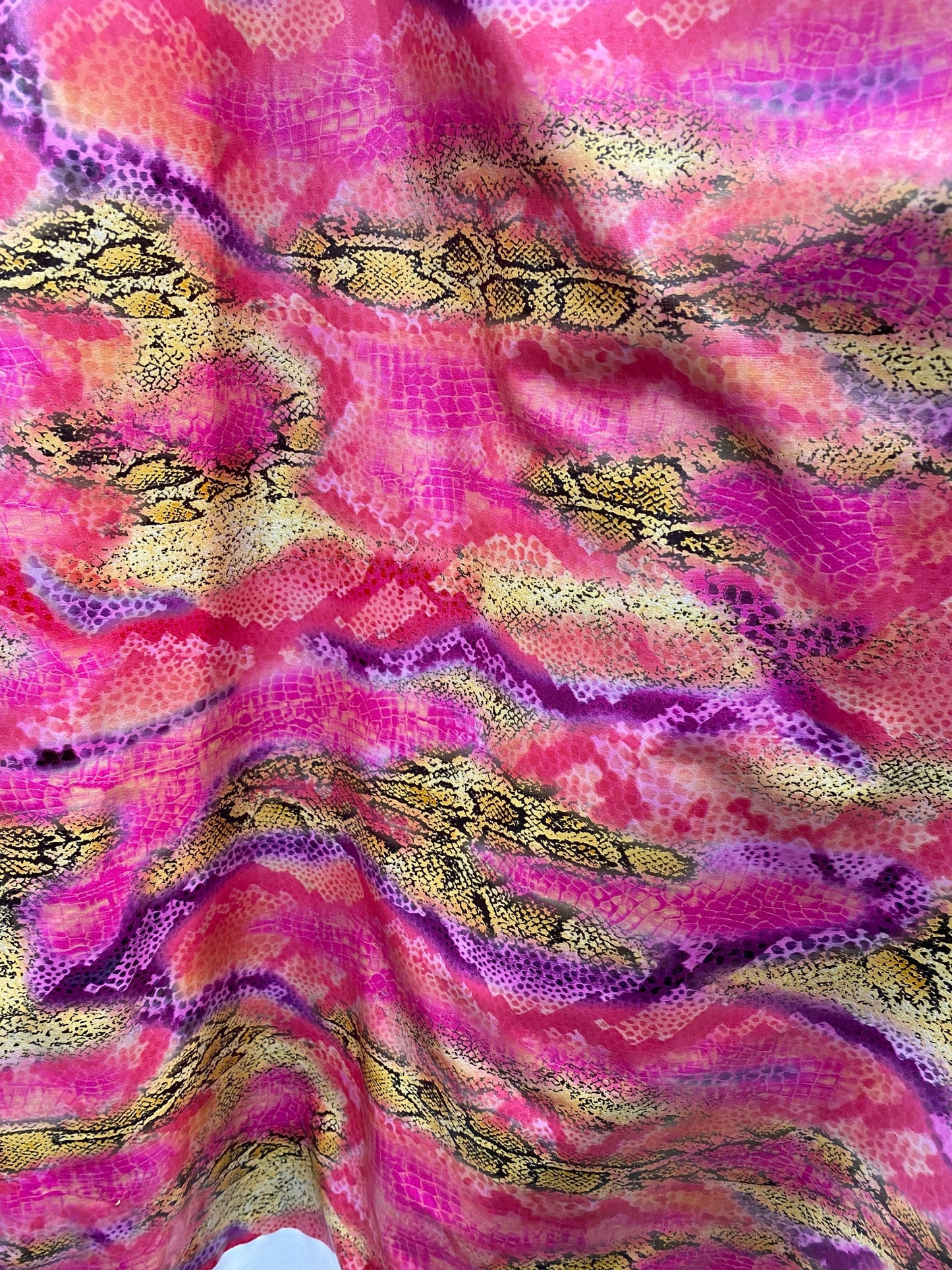 New Exotic snake design pink multicolor print on poly spandex multicolor with all over foil 2-way stretch 58/60” Sold by the YD.