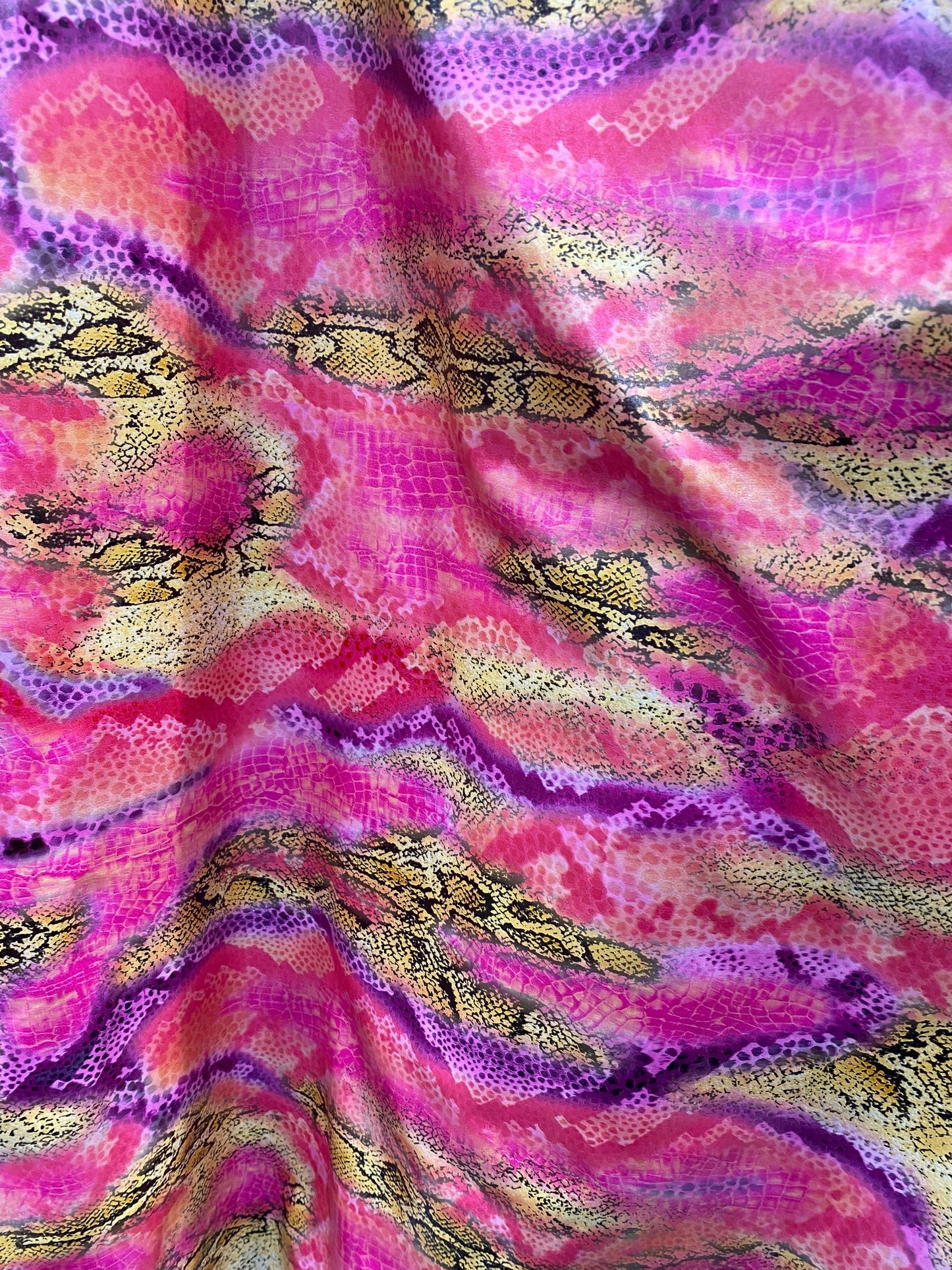 New Exotic snake design pink multicolor print on poly spandex multicolor with all over foil 2-way stretch 58/60” Sold by the YD.