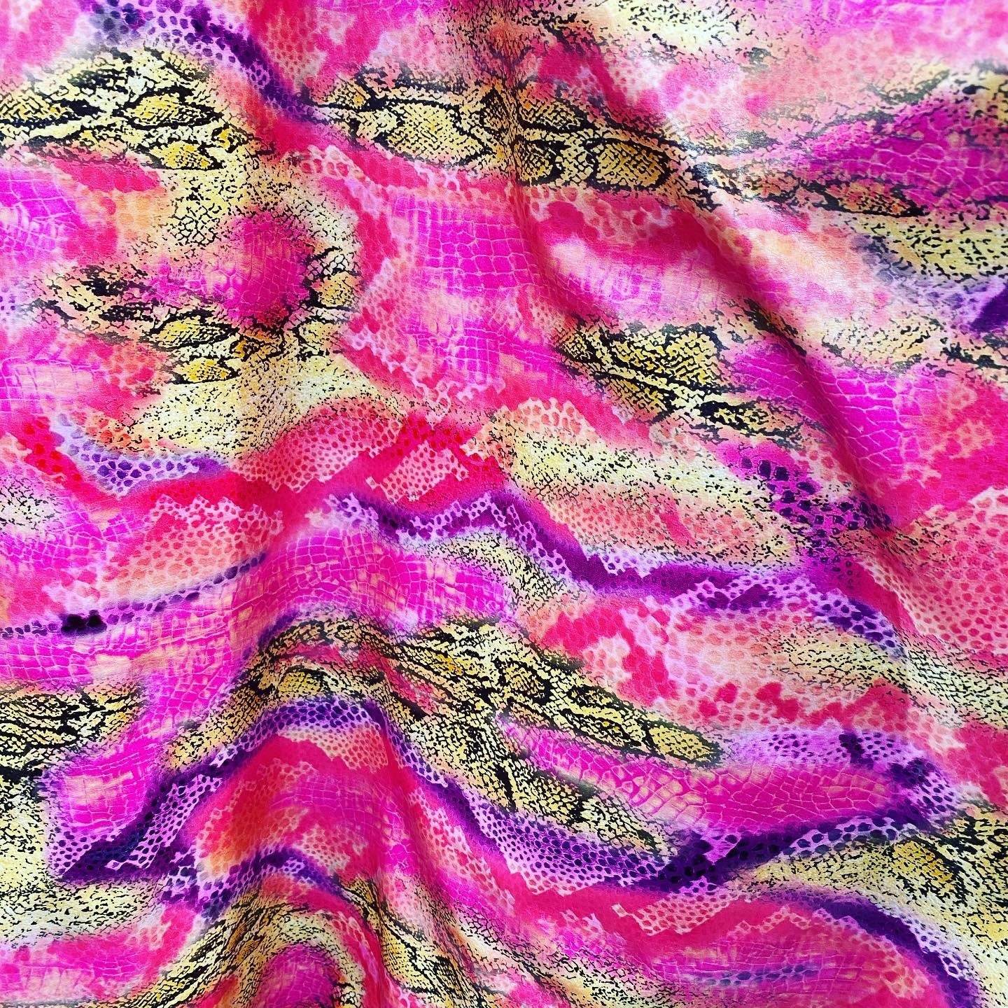 New Exotic snake design pink multicolor print on poly spandex multicolor with all over foil 2-way stretch 58/60” Sold by the YD.