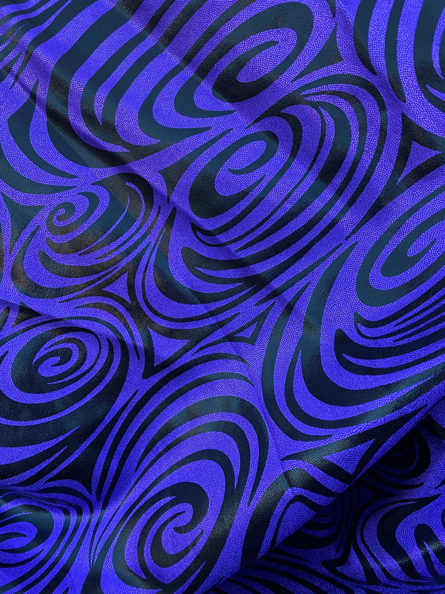 Swirl design print on purple foggy foil metallic nylon spandex 4-way stretch 58/60” Sold by the YD. Ships Worldwide from L.A