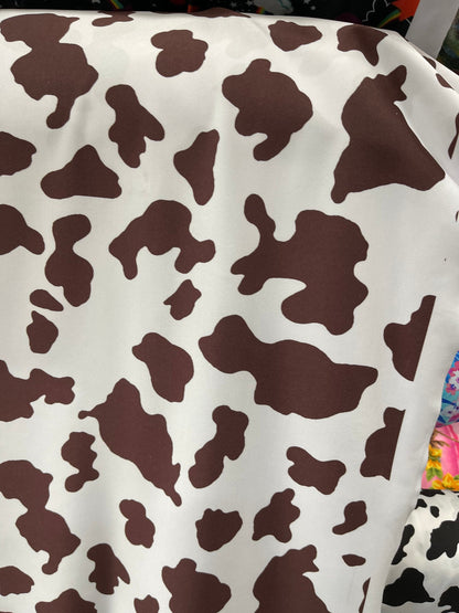 Cow design white/brown print on great quality of nylon spandex 4-way stretch 58/60” Sold by the YD. Ships Worldwide from Los Angeles Califor