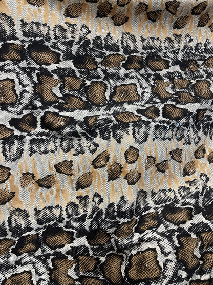 New Exotic snake skin design print on poly spandex with clear sequins 4-way stretch medium weight 58/60” Sold by the YD. Ships Worldwide