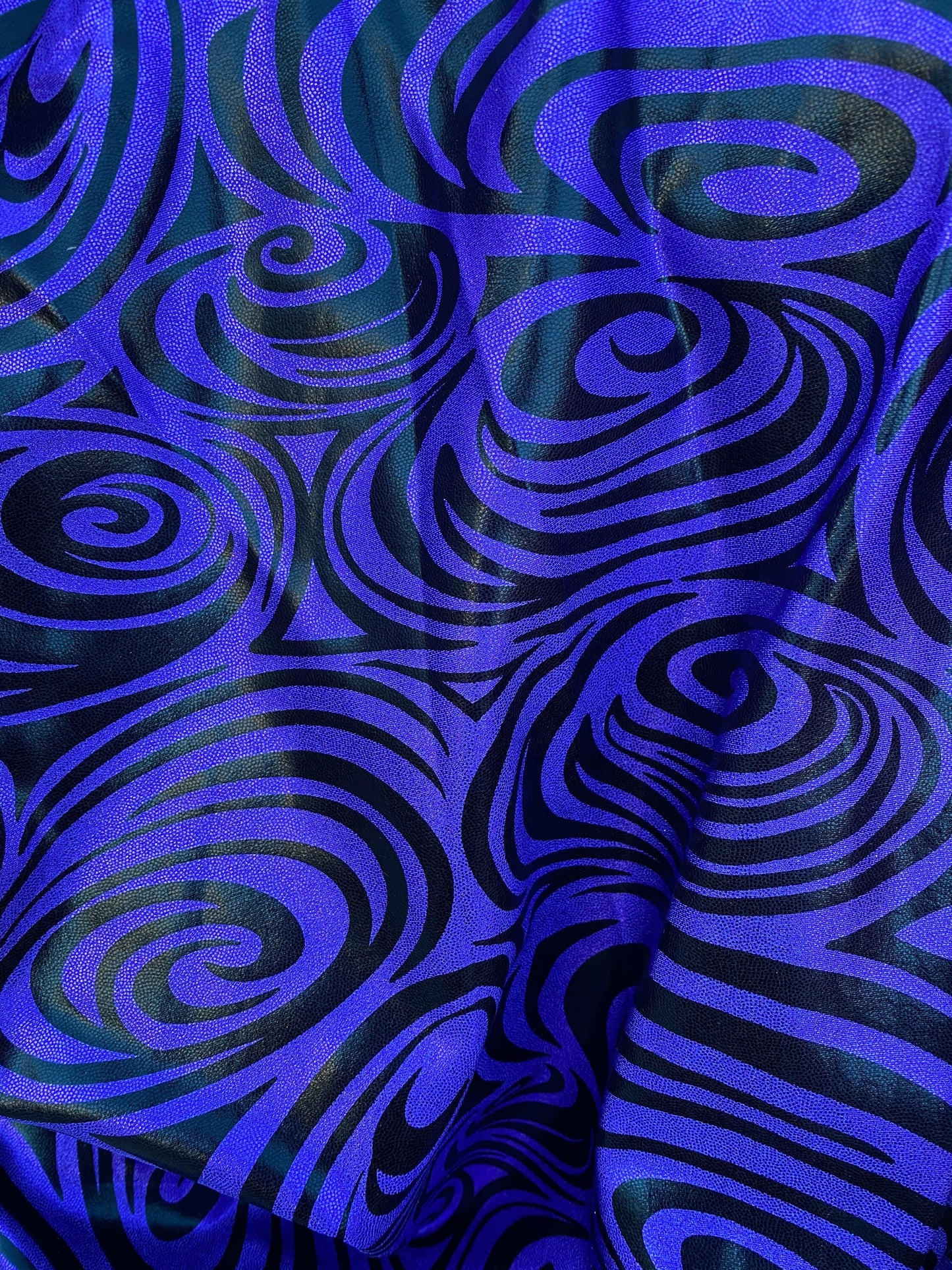 Swirl design print on purple foggy foil metallic nylon spandex 4-way stretch 58/60” Sold by the YD. Ships Worldwide from L.A