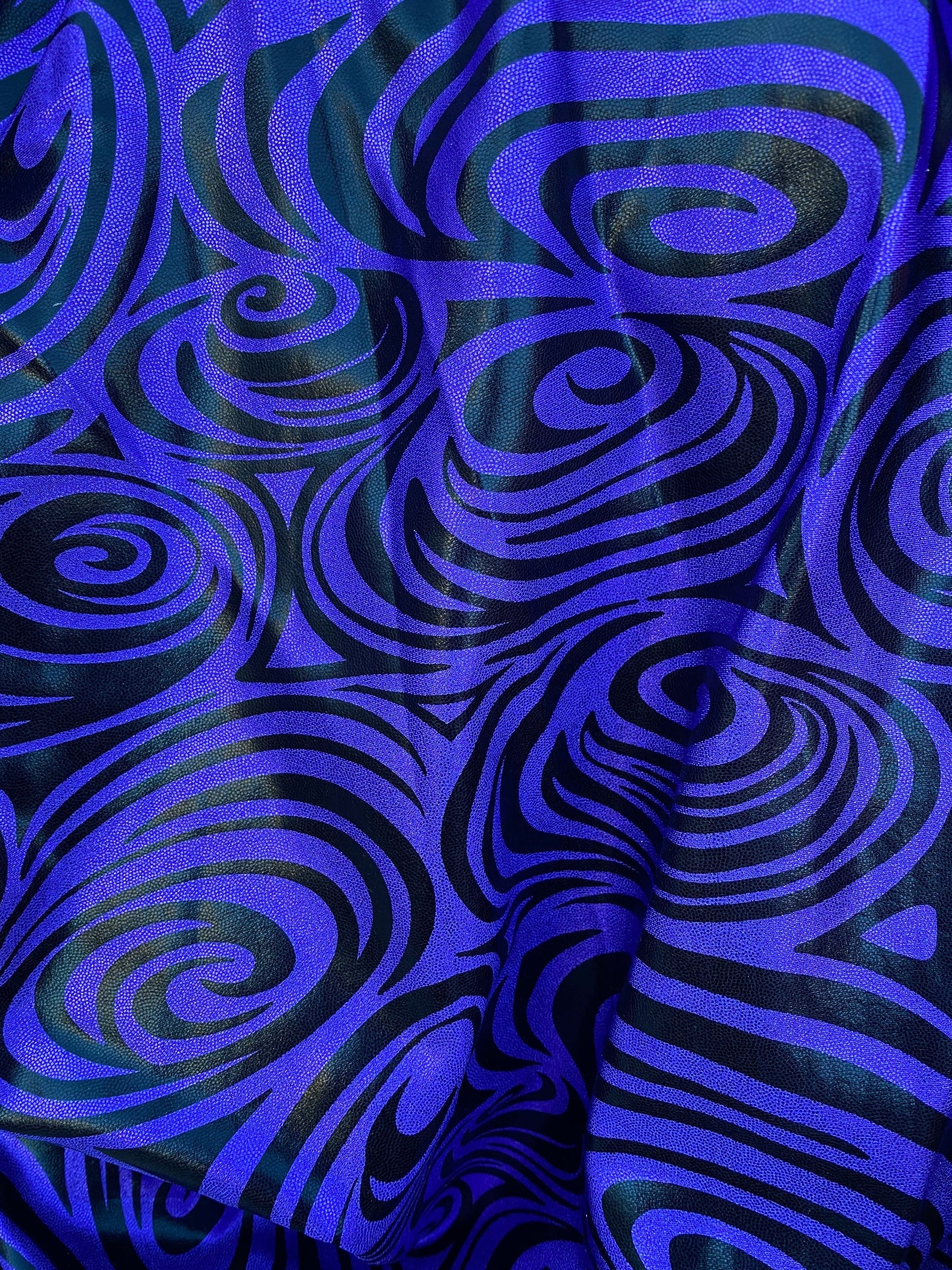 Swirl design print on purple foggy foil metallic nylon spandex 4-way stretch 58/60” Sold by the YD. Ships Worldwide from L.A