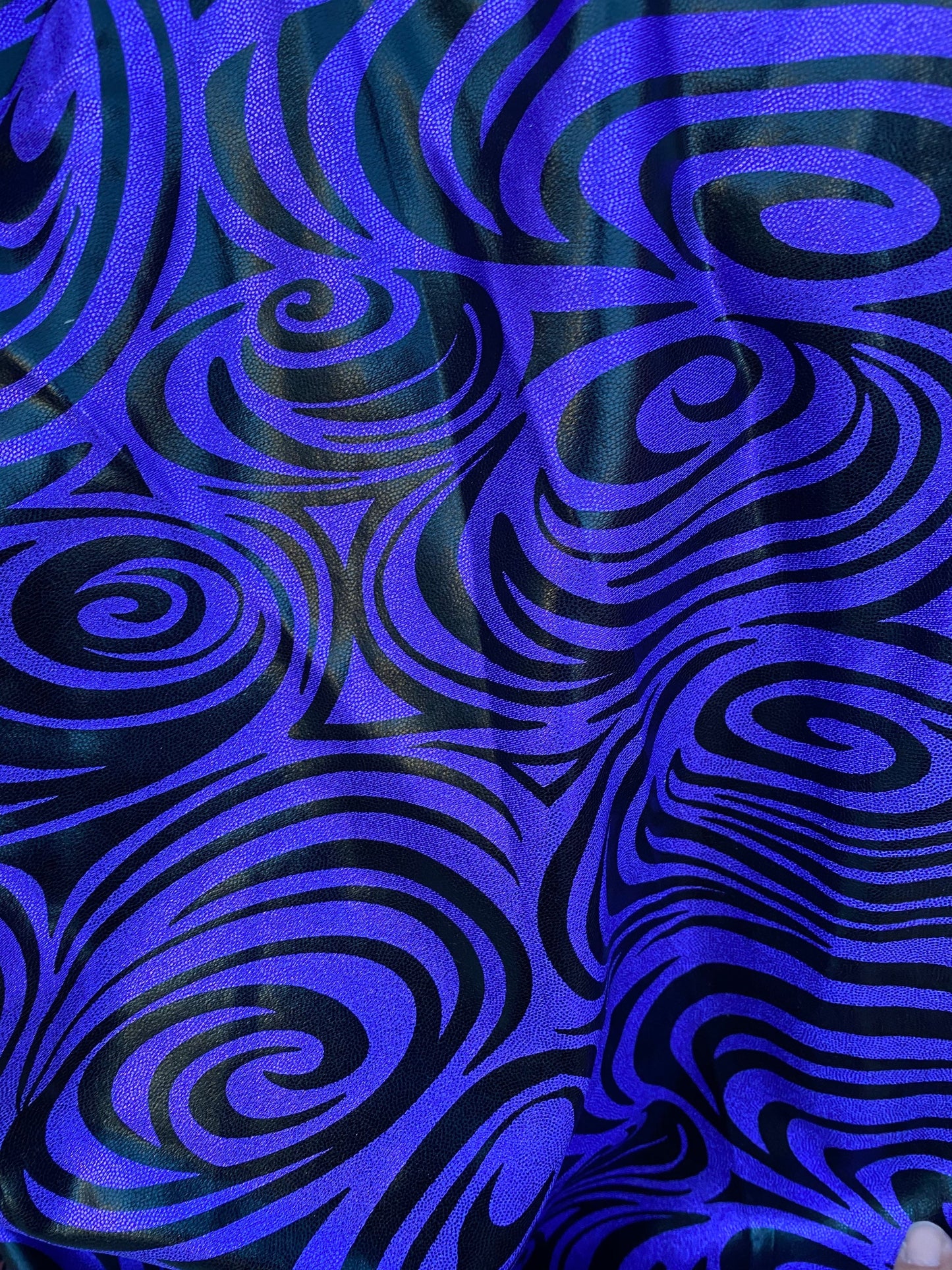 Swirl design print on purple foggy foil metallic nylon spandex 4-way stretch 58/60” Sold by the YD. Ships Worldwide from L.A