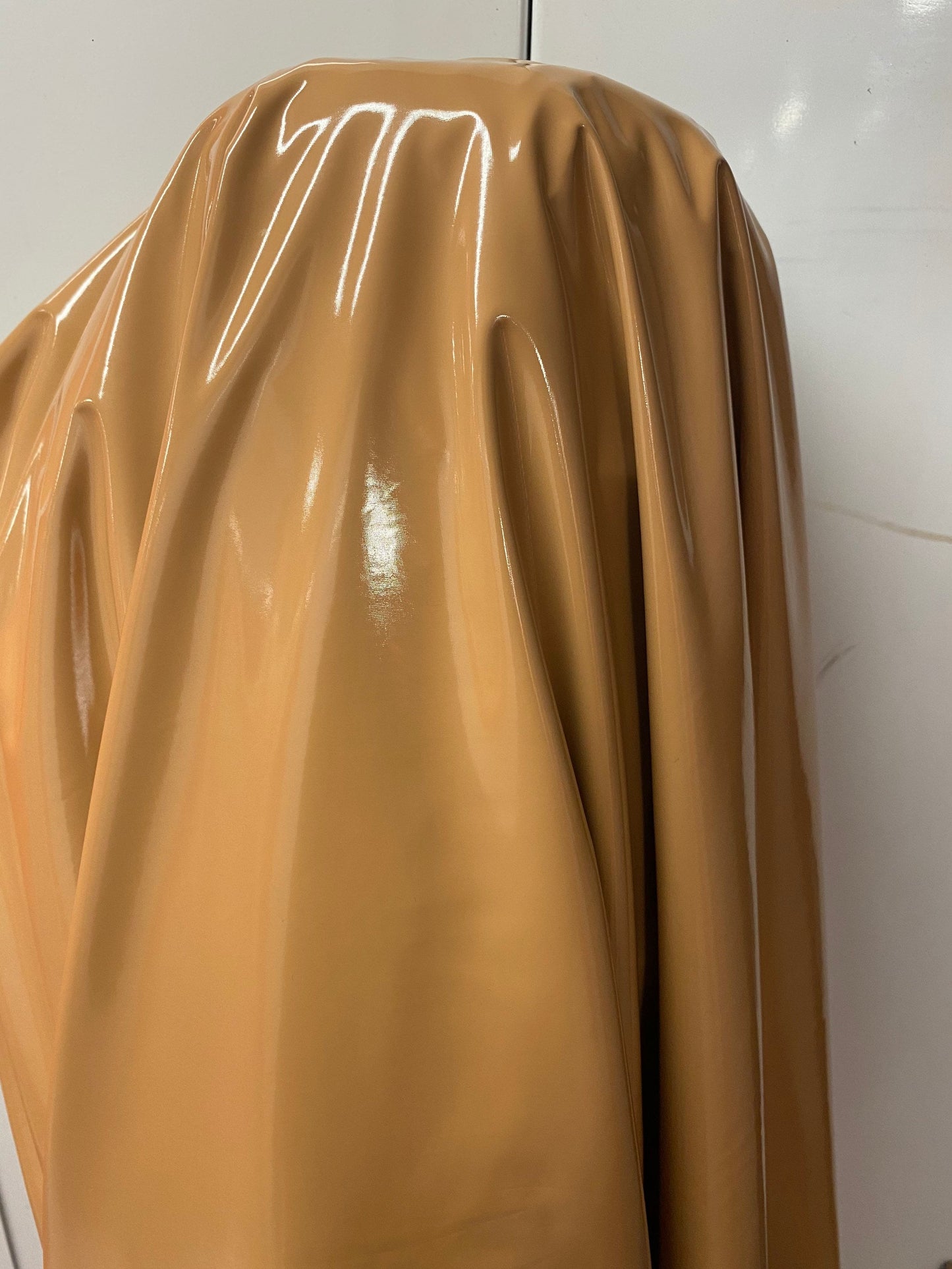 Shiny Latex Cappuccino color nylon spandex 4way stretch 58/60” Sold by the YD. Ships worldwide from Los Angeles California USA.