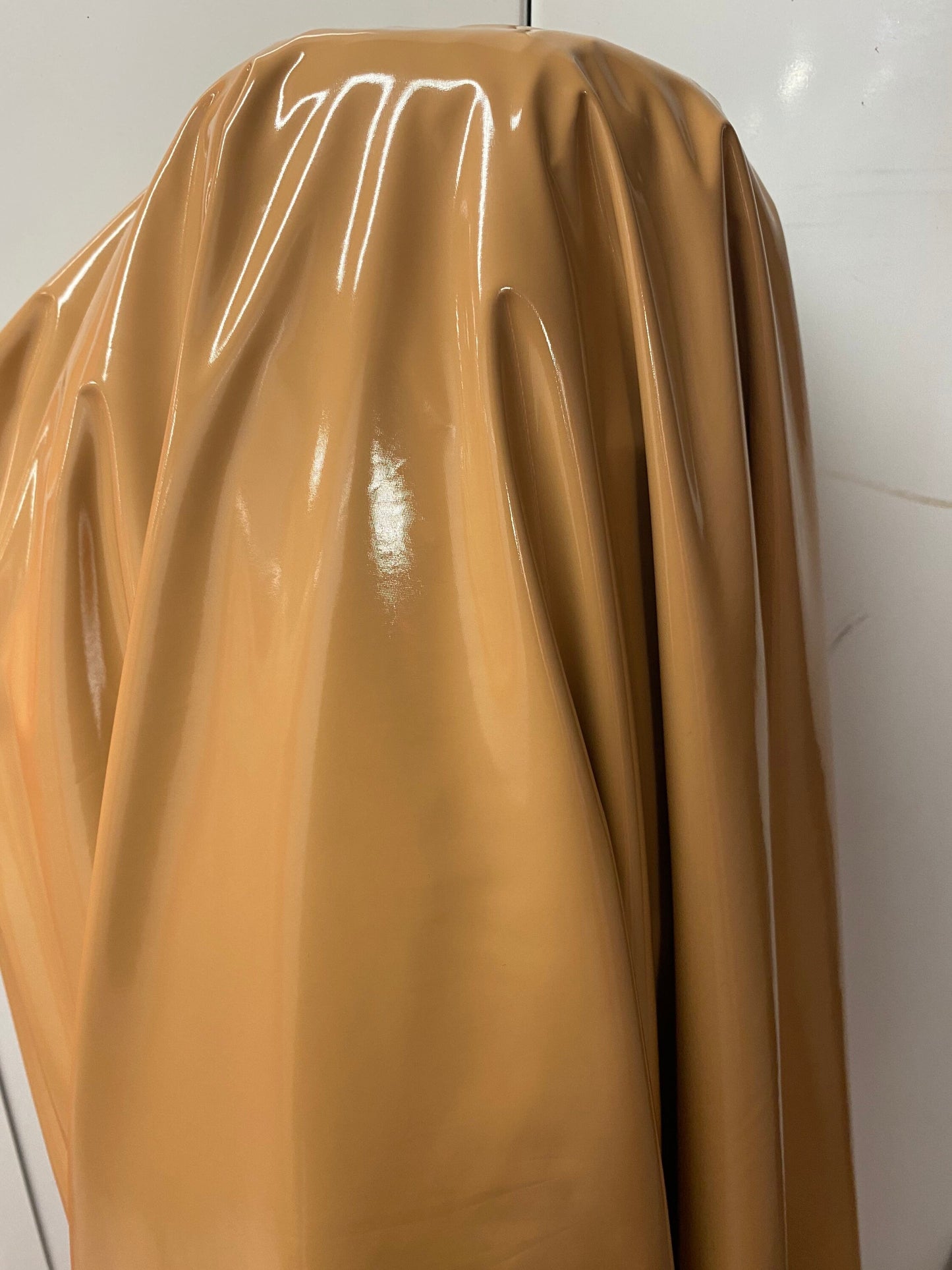 Shiny Latex Cappuccino color nylon spandex 4way stretch 58/60” Sold by the YD. Ships worldwide from Los Angeles California USA.