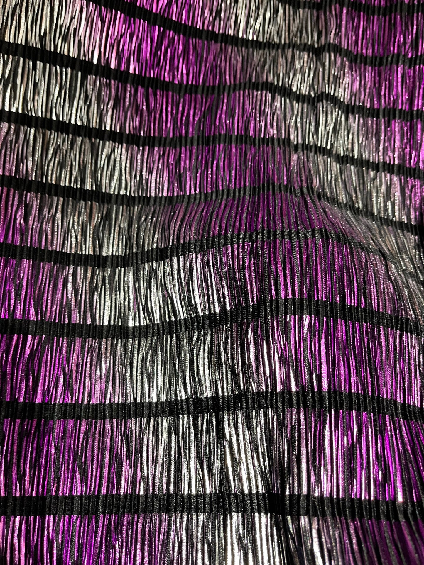 Pleated metallic poly spandex with foil ombré design 2-way stretch 58/60” Sold by the YD. Ships Worldwide from Los Angeles California USA.