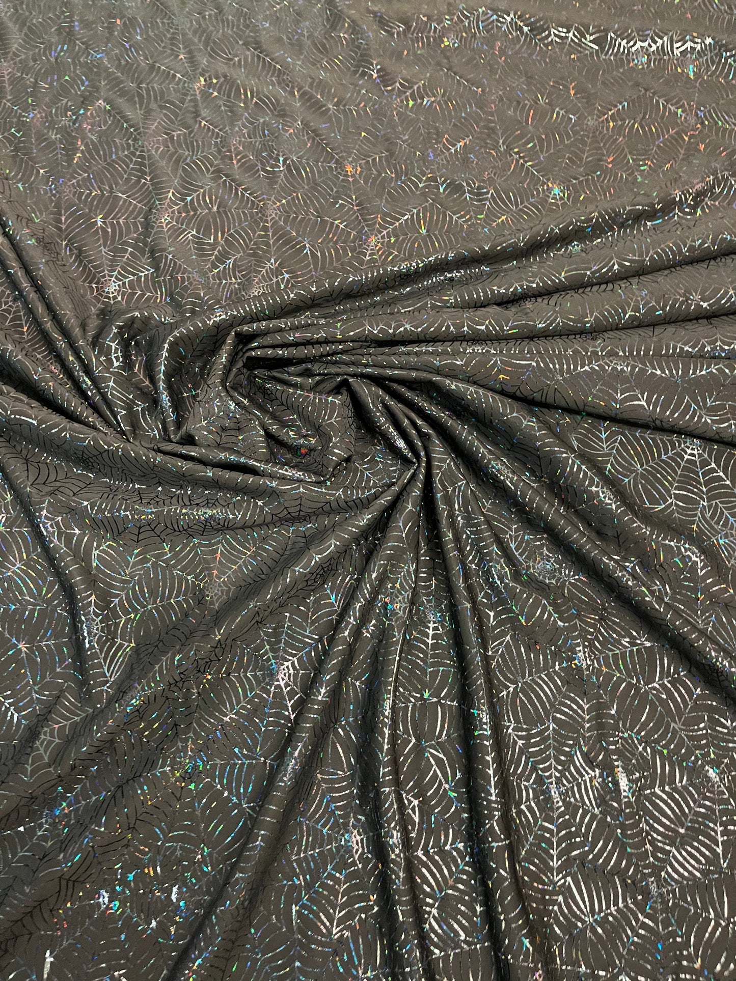 Spiderweb design black/black hologram nylon spandex 4-way stretch 58/60” Sold by the YD. Ships Worldwide from Los Angeles California USA.