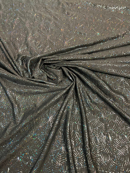 Spiderweb design black/black hologram nylon spandex 4-way stretch 58/60” Sold by the YD. Ships Worldwide from Los Angeles California USA.