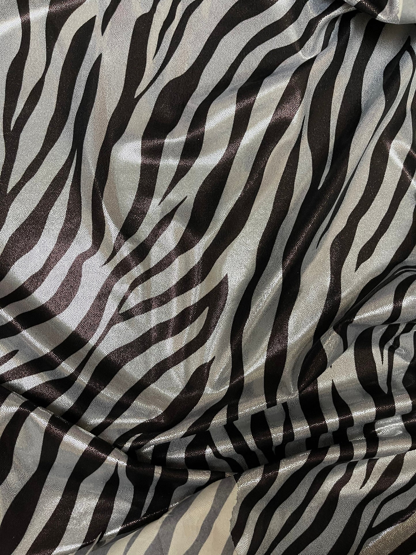 Exotic Zebra design print on metallic nylon spandex with foggy foil 4-way stretch 58/60” Sold by the YD. Ships Worldwide from Los Angeles CA