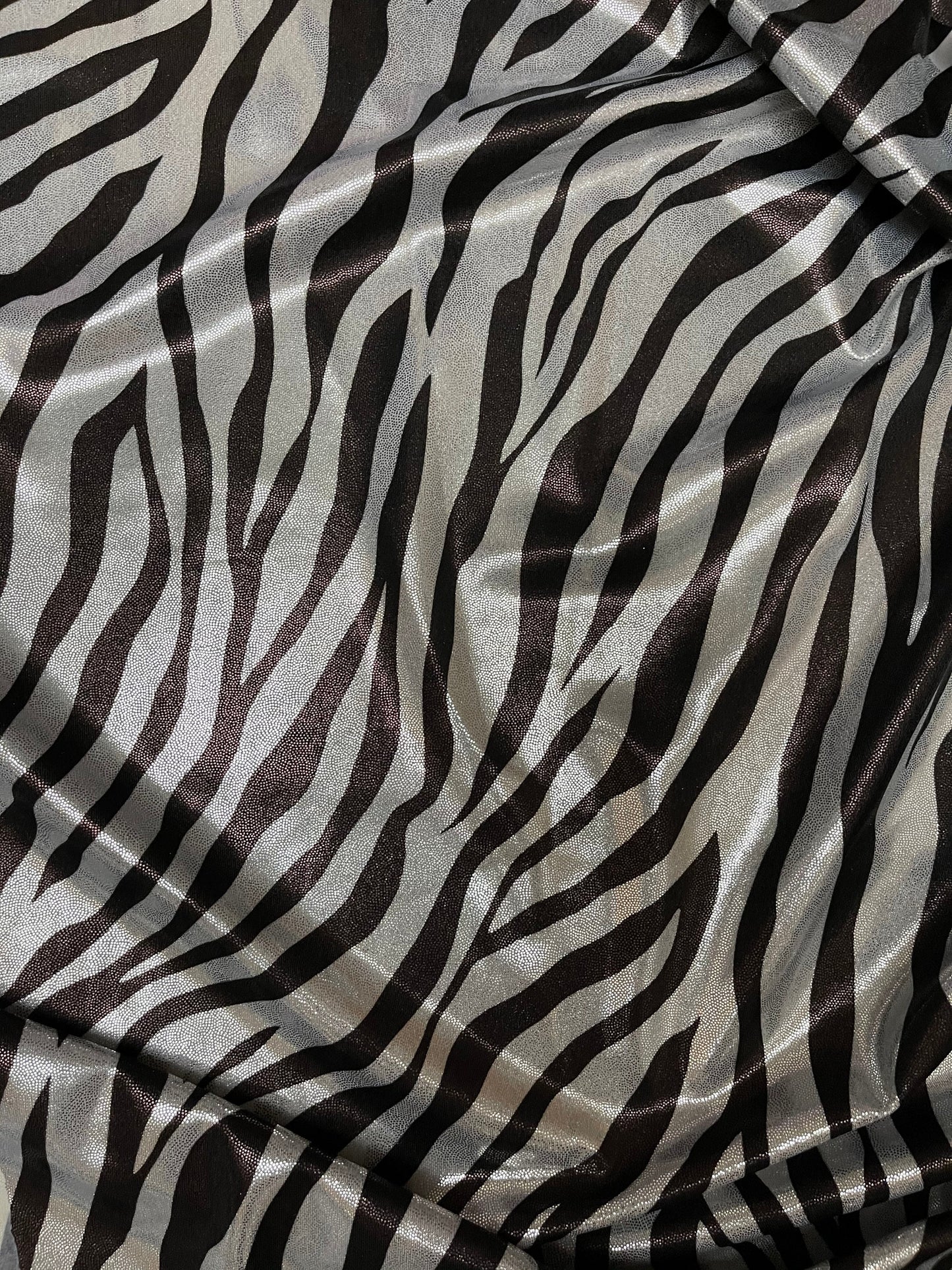 Exotic Zebra design print on metallic nylon spandex with foggy foil 4-way stretch 58/60” Sold by the YD. Ships Worldwide from Los Angeles CA