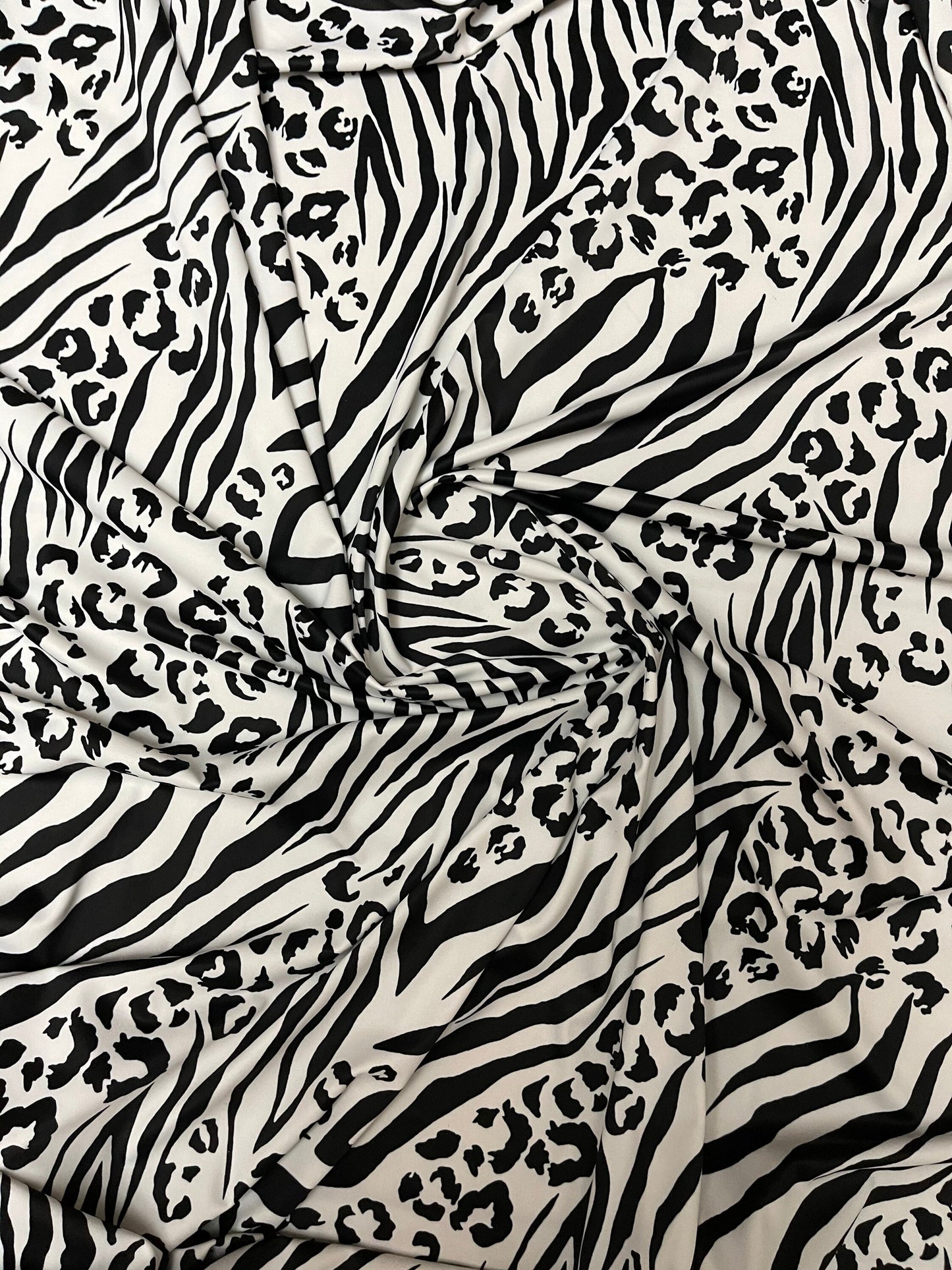 Exotic animal print white/black print on nylon spandex 4-way stretch 58/60” Sold by the YD. Ships Worldwide from Los Angeles California USA.