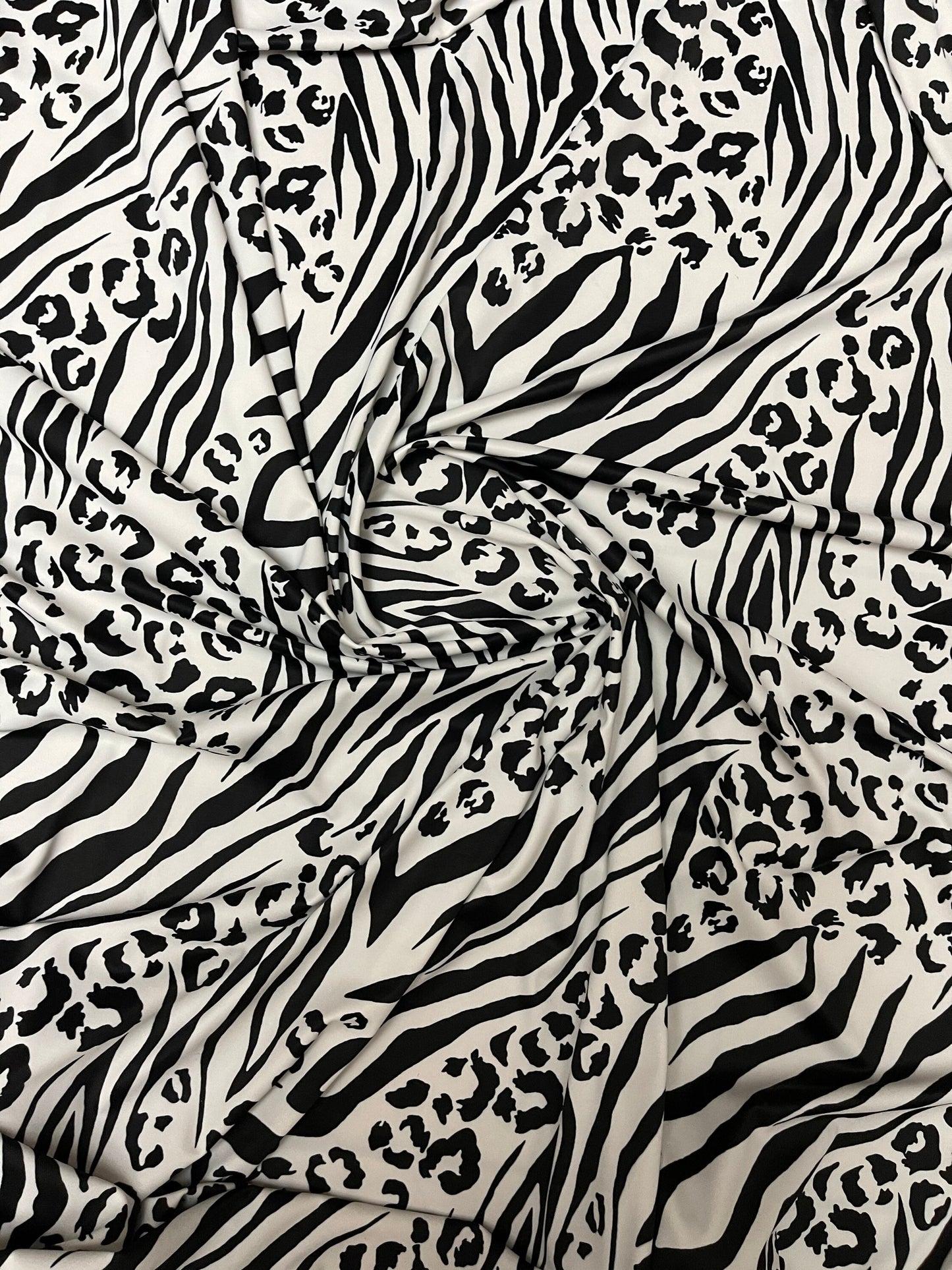 Exotic animal print white/black print on nylon spandex 4-way stretch 58/60” Sold by the YD. Ships Worldwide from Los Angeles California USA.