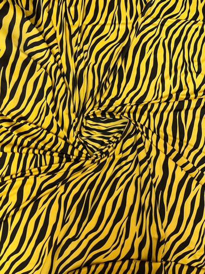 Exotic zebra design yellow/black print on nylon spandex 4-way stretch 58/60” Sold by the YD. Ships Worldwide from Los Angeles California USA