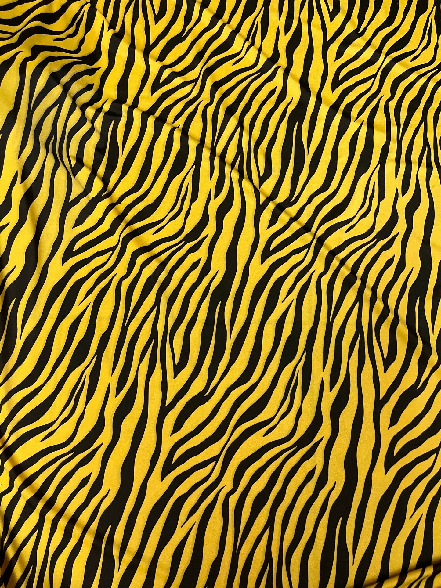 Exotic zebra design yellow/black print on nylon spandex 4-way stretch 58/60” Sold by the YD. Ships Worldwide from Los Angeles California USA