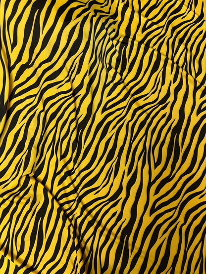 Exotic zebra design yellow/black print on nylon spandex 4-way stretch 58/60” Sold by the YD. Ships Worldwide from Los Angeles California USA