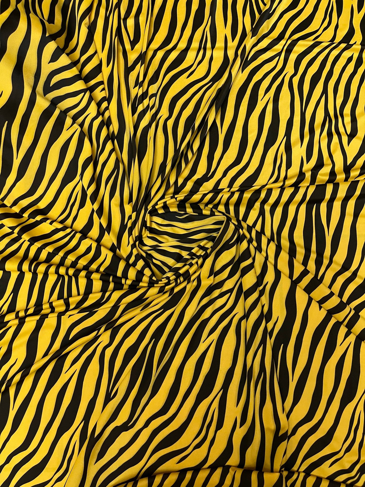 Exotic zebra design yellow/black print on nylon spandex 4-way stretch 58/60” Sold by the YD. Ships Worldwide from Los Angeles California USA