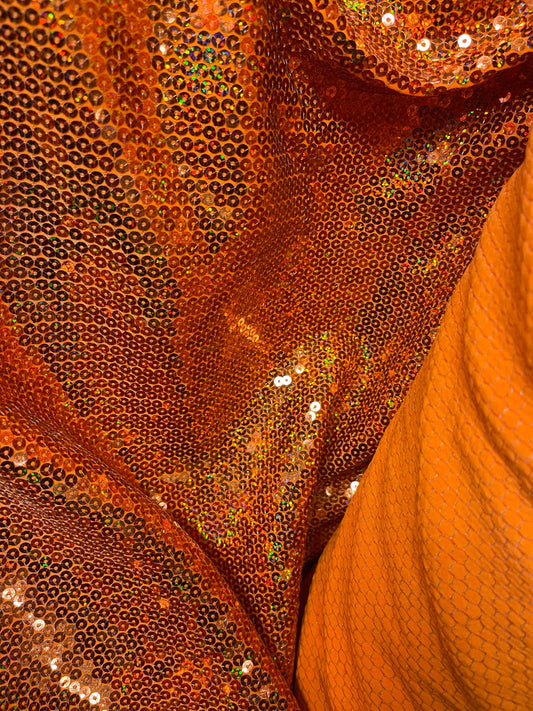 Hologram neon orange sequins embroidered on stretch spandex base 2-way 58/60” Sold by the YD. Ships Worldwide from Los Angeles California US