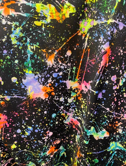 New splatter paint design Black/Multicolor print on nylon spandex 4-way stretch 58/60” Sold by the YD. It glow in the dark with Black Light