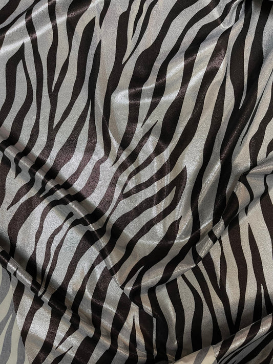 Exotic Zebra design print on metallic nylon spandex with foggy foil 4-way stretch 58/60” Sold by the YD. Ships Worldwide from Los Angeles CA