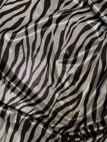 Exotic Zebra design print on metallic nylon spandex with foggy foil 4-way stretch 58/60” Sold by the YD. Ships Worldwide from Los Angeles CA