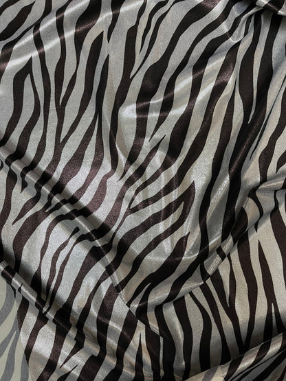 Exotic Zebra design print on metallic nylon spandex with foggy foil 4-way stretch 58/60” Sold by the YD. Ships Worldwide from Los Angeles CA