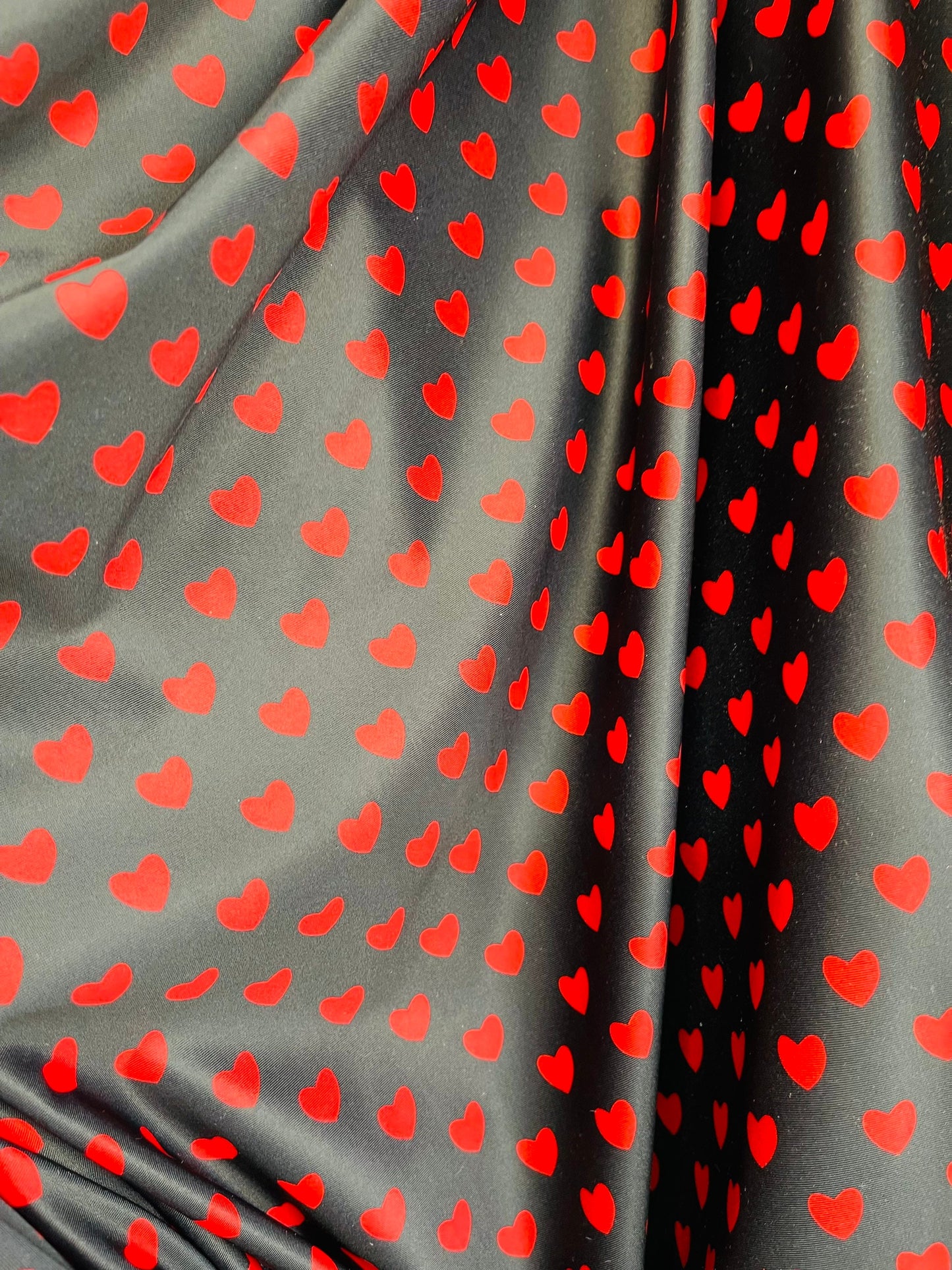 Hearts design black/red print on best quality of nylon spandex 4-way stretch 58/60” Sold by the YD. Ships Worldwide from Los Angeles cali.