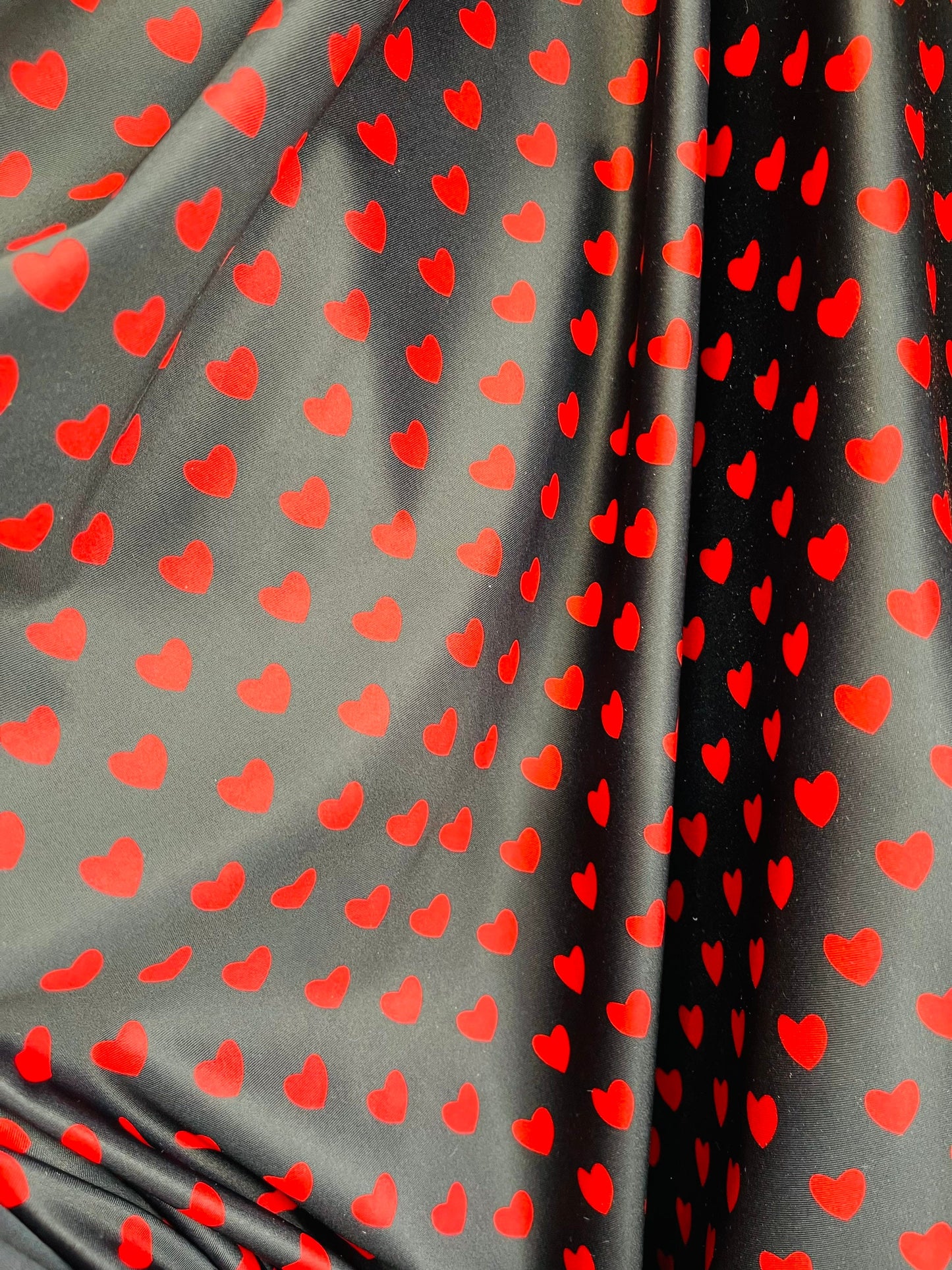 Hearts design black/red print on best quality of nylon spandex 4-way stretch 58/60” Sold by the YD. Ships Worldwide from Los Angeles cali.