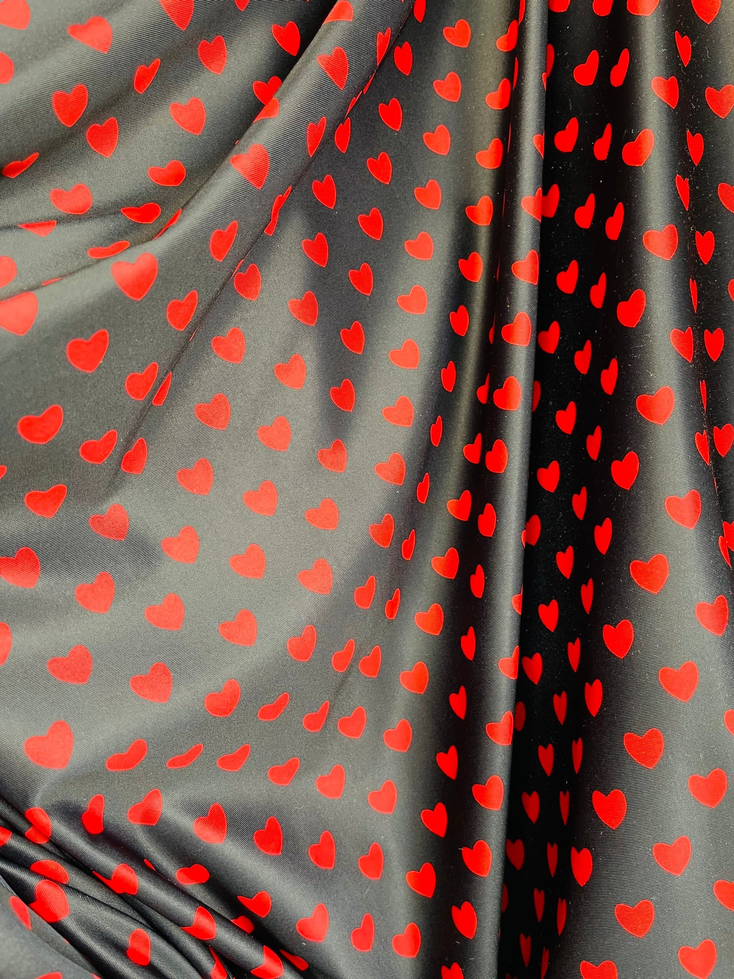 Hearts design black/red print on best quality of nylon spandex 4-way stretch 58/60” Sold by the YD. Ships Worldwide from Los Angeles cali.