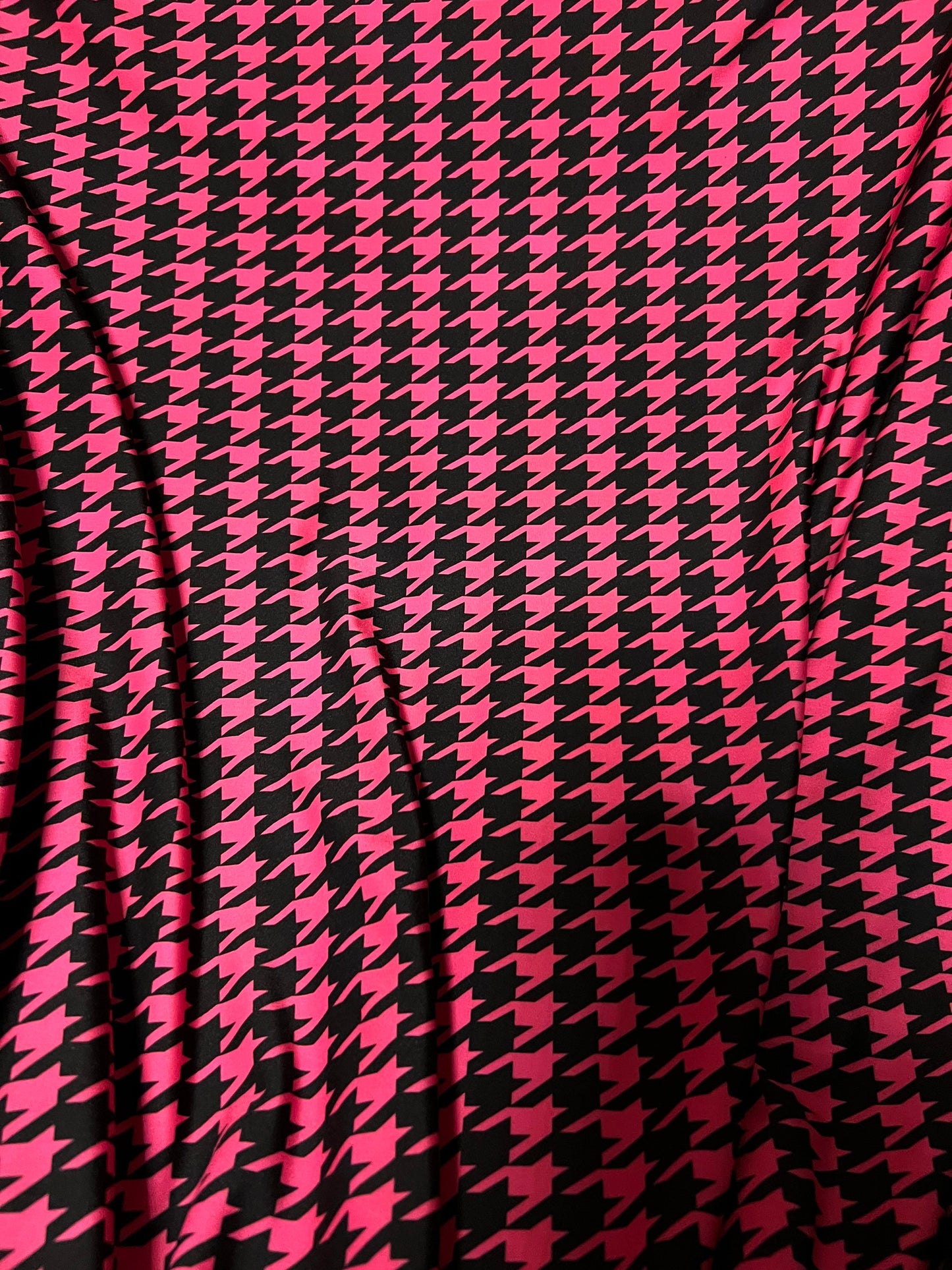 New houndstooth design hot pink/black print on poly spandex 4way stretch 58/60" Sold by the YD. Ships worldwide from Los Angeles California.