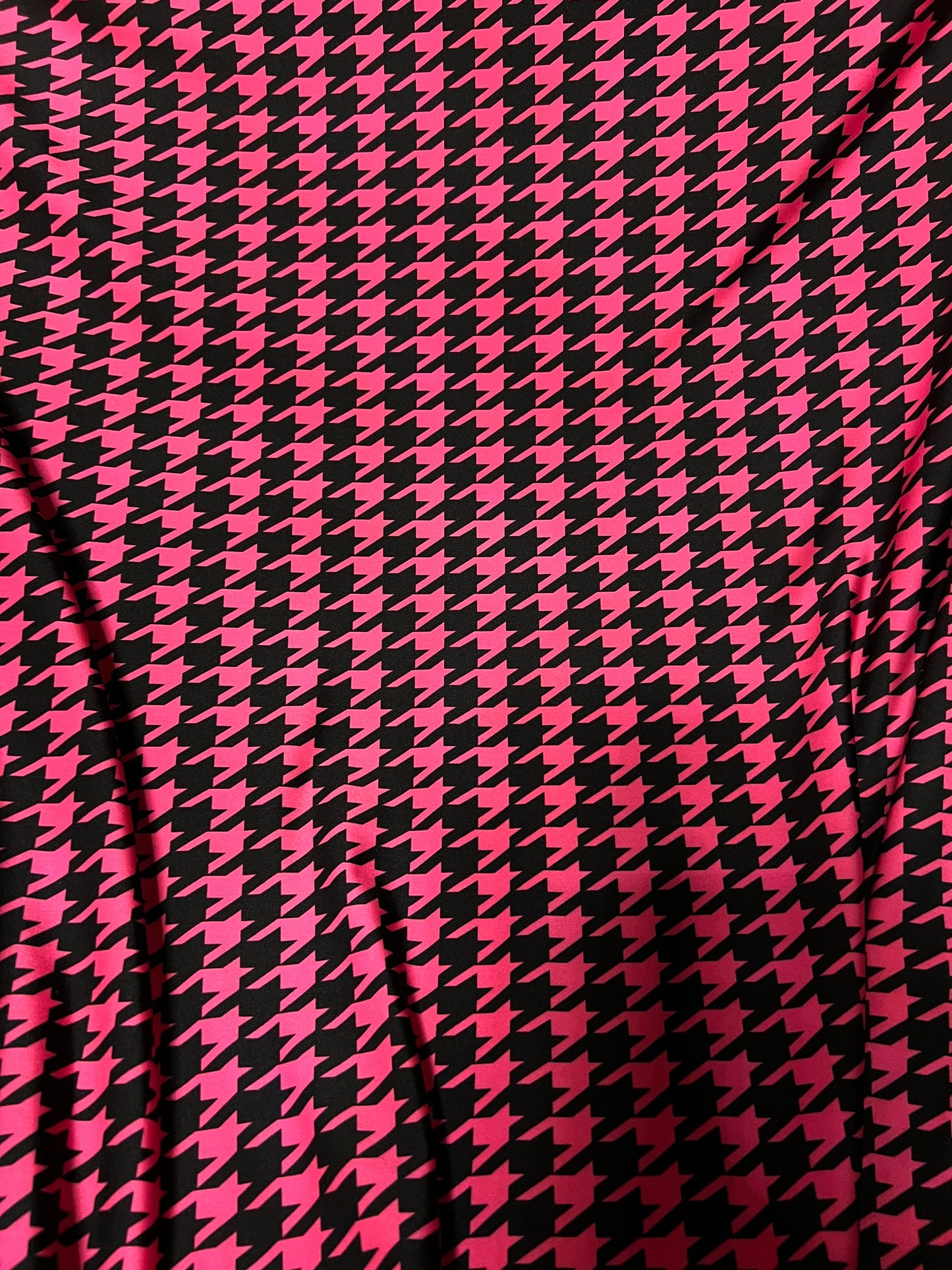 New houndstooth design hot pink/black print on poly spandex 4way stretch 58/60" Sold by the YD. Ships worldwide from Los Angeles California.