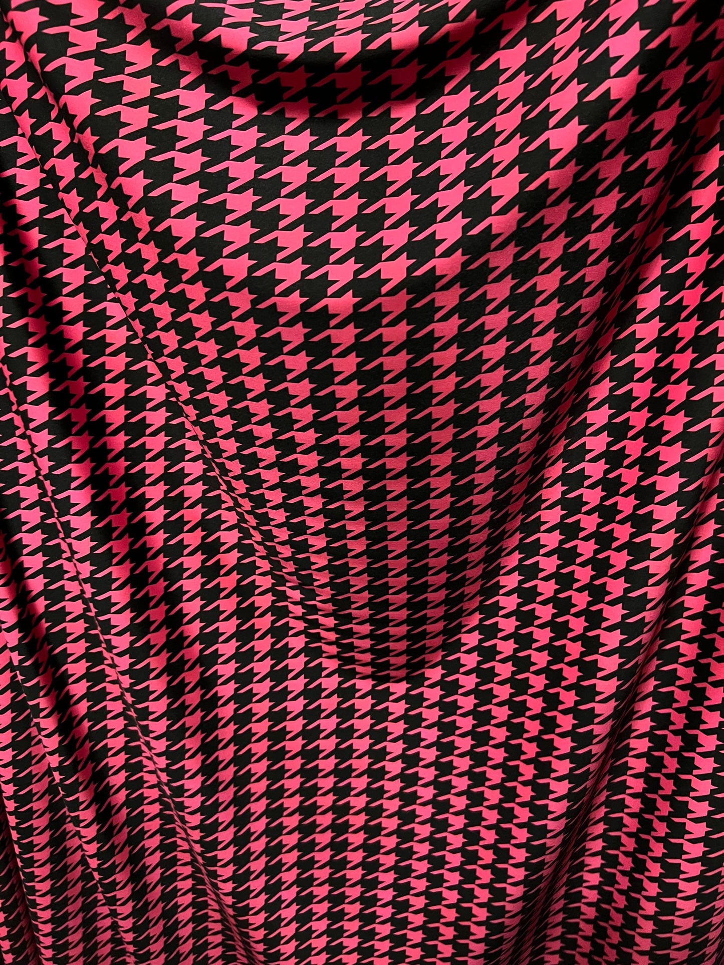 New houndstooth design hot pink/black print on poly spandex 4way stretch 58/60" Sold by the YD. Ships worldwide from Los Angeles California.