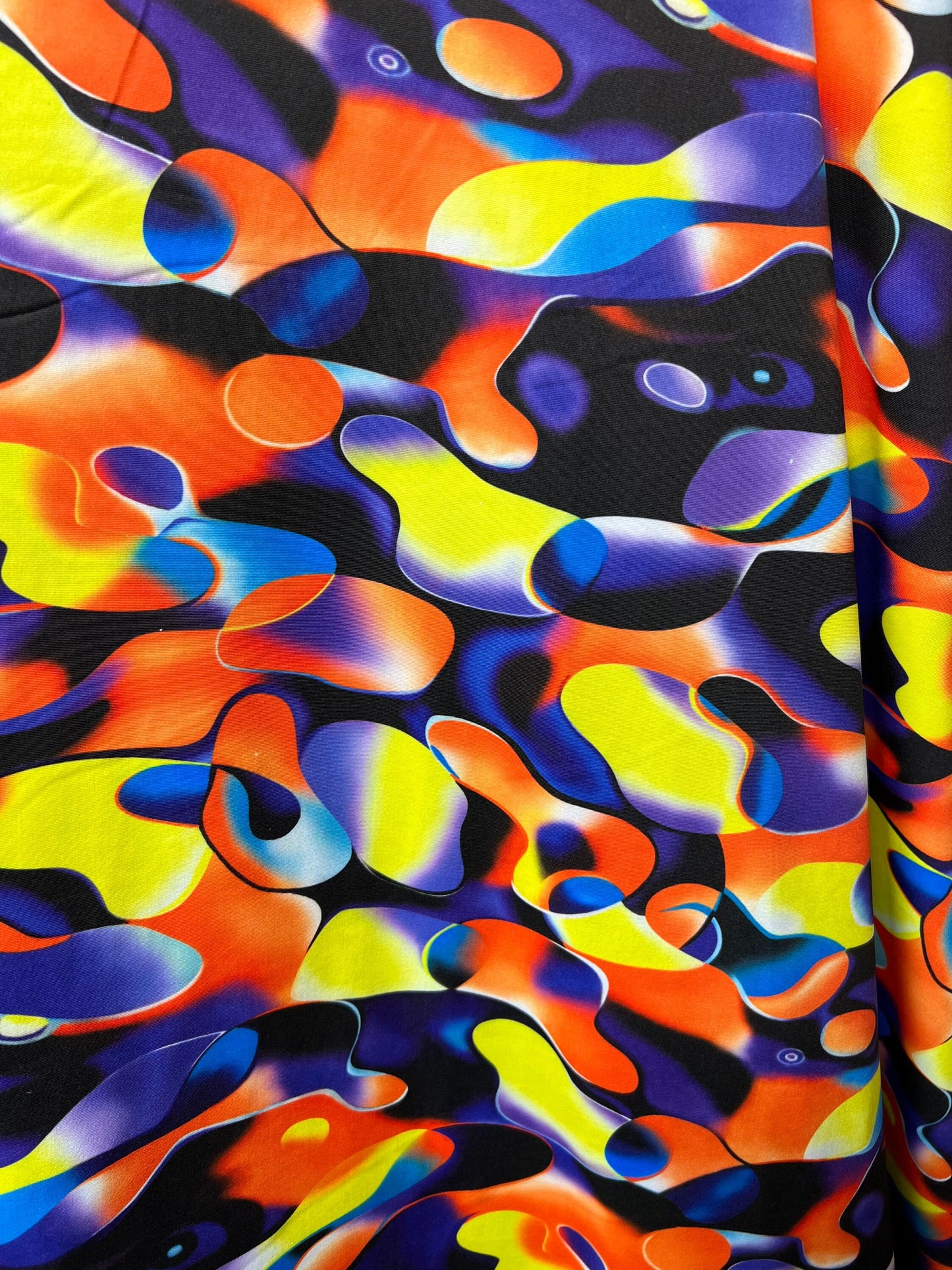 New UV light reflective abstract design Multicolor Neon Bubble Bubble print heavy nylon spandex 4-way stretch 58/60” Sold by the YD.