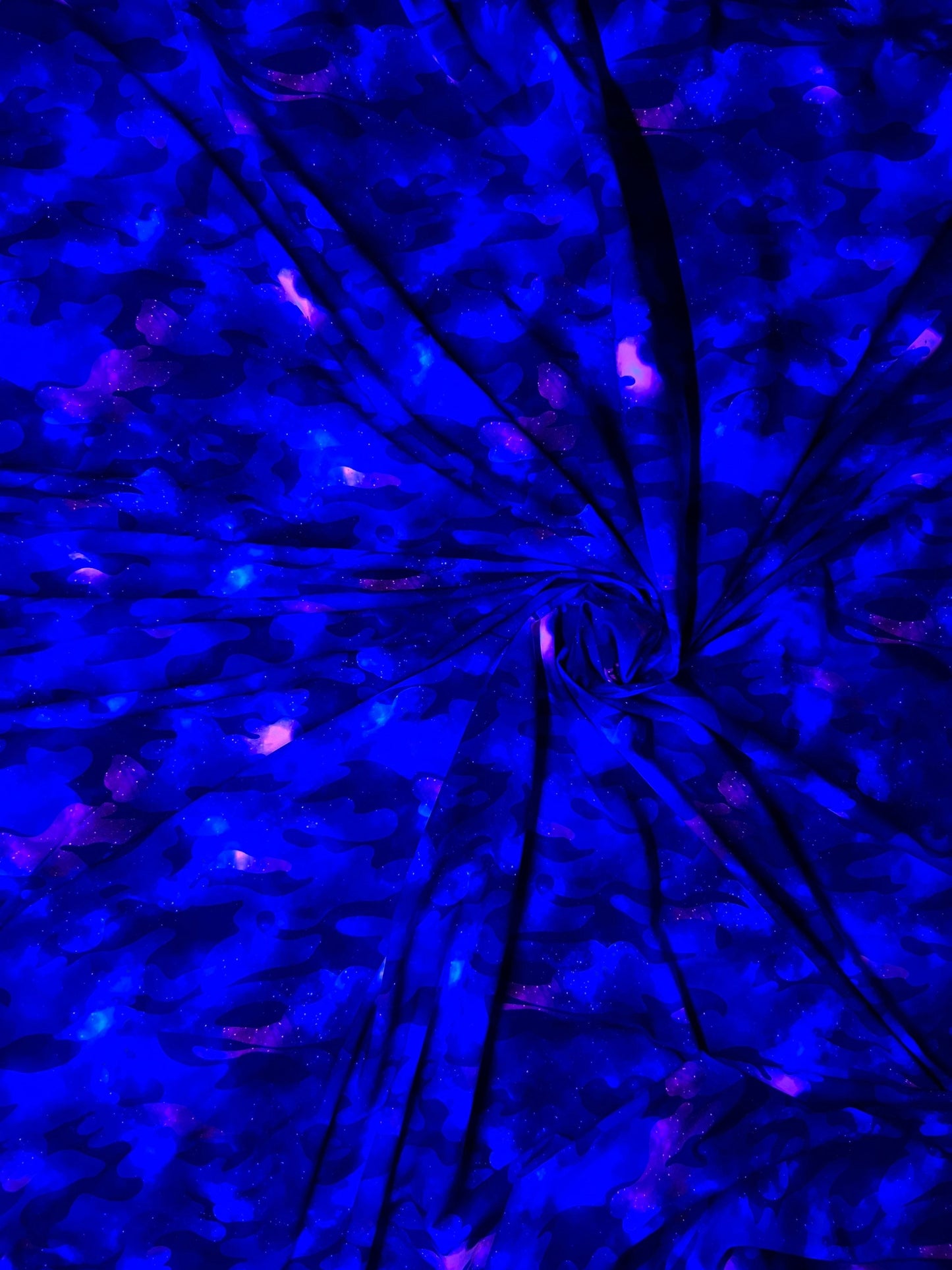 Camouflage UV-light it glows in the dark with black light great quality of nylon spandex 4-way stretch 58/60” Sold by the YD.