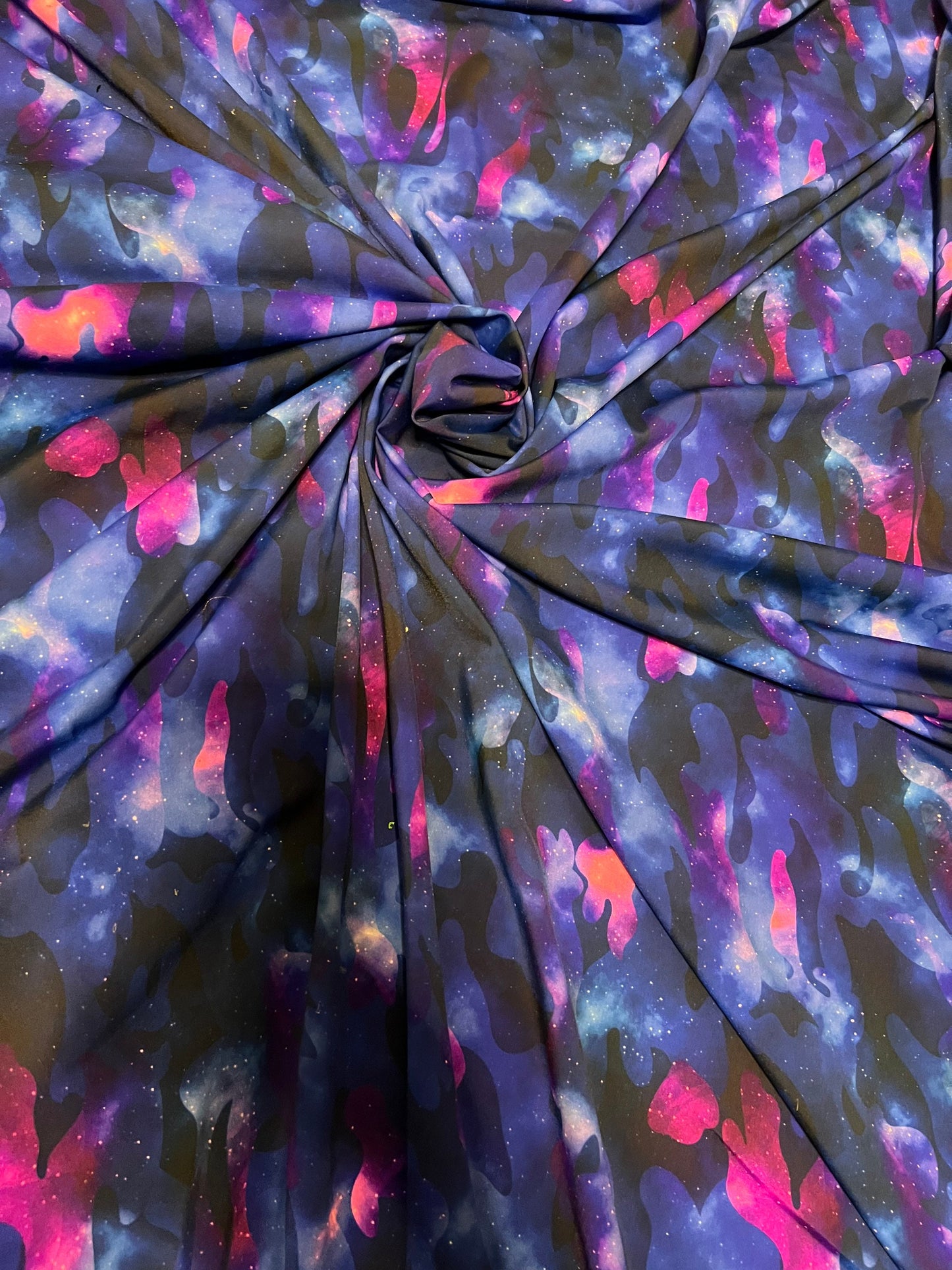 Camouflage UV-light it glows in the dark with black light great quality of nylon spandex 4-way stretch 58/60” Sold by the YD.