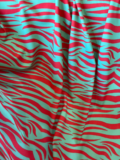 New Exotic zebra design Green/Red print on great quality of nylon spandex 4-way stretch 58/60” Sold by the YD. Ships Worldwide from L.A