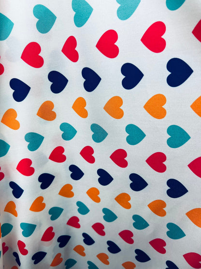 Romantic Hearts design white/multicolor print on great quality of nylon spandex 4-way stretch 58/60” Sold by the YD. Ships  Worldwide