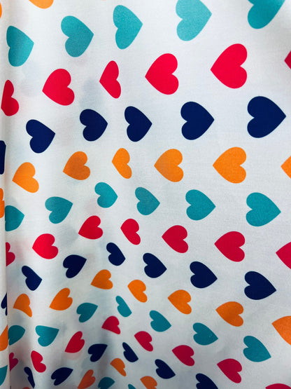 Romantic Hearts design white/multicolor print on great quality of nylon spandex 4-way stretch 58/60” Sold by the YD. Ships  Worldwide