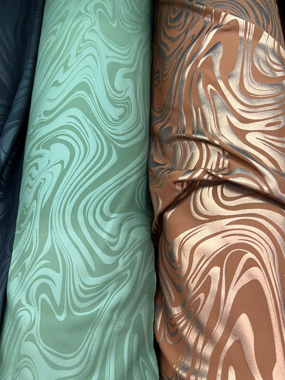 New Modern abstract design foiled nylon spandex 4 way stretch 58/60” Sold by the YD.