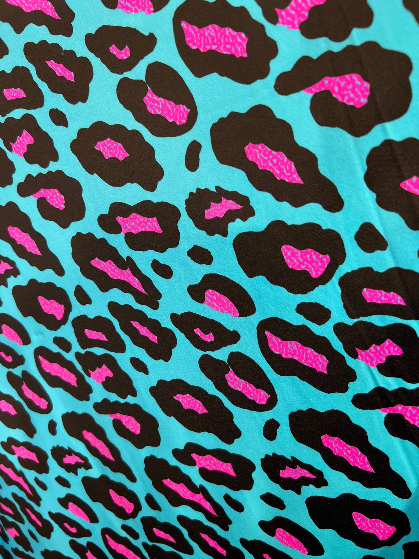 New Exotic Leopard design Turquoise/Pink it glows in the dark with black light 4-way stretch 58/60” Sold by the YD. Ships Worldwide from L.A