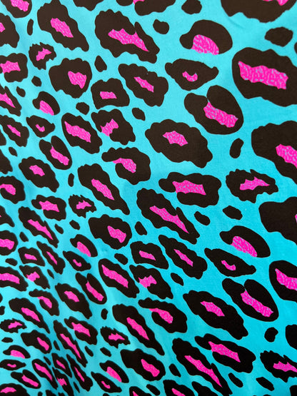 New Exotic Leopard design Turquoise/Pink it glows in the dark with black light 4-way stretch 58/60” Sold by the YD. Ships Worldwide from L.A