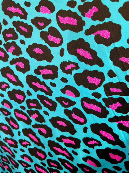 New Exotic Leopard design Turquoise/Pink it glows in the dark with black light 4-way stretch 58/60” Sold by the YD. Ships Worldwide from L.A