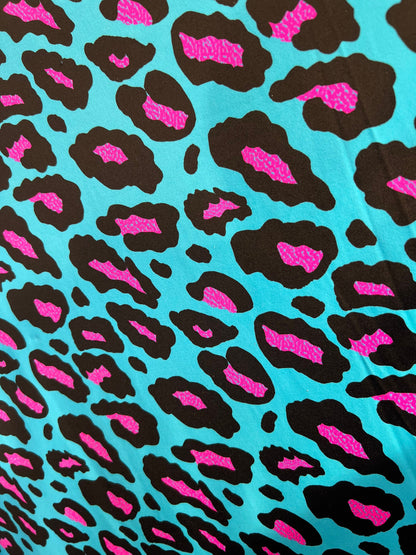 New Exotic Leopard design Turquoise/Pink it glows in the dark with black light 4-way stretch 58/60” Sold by the YD. Ships Worldwide from L.A