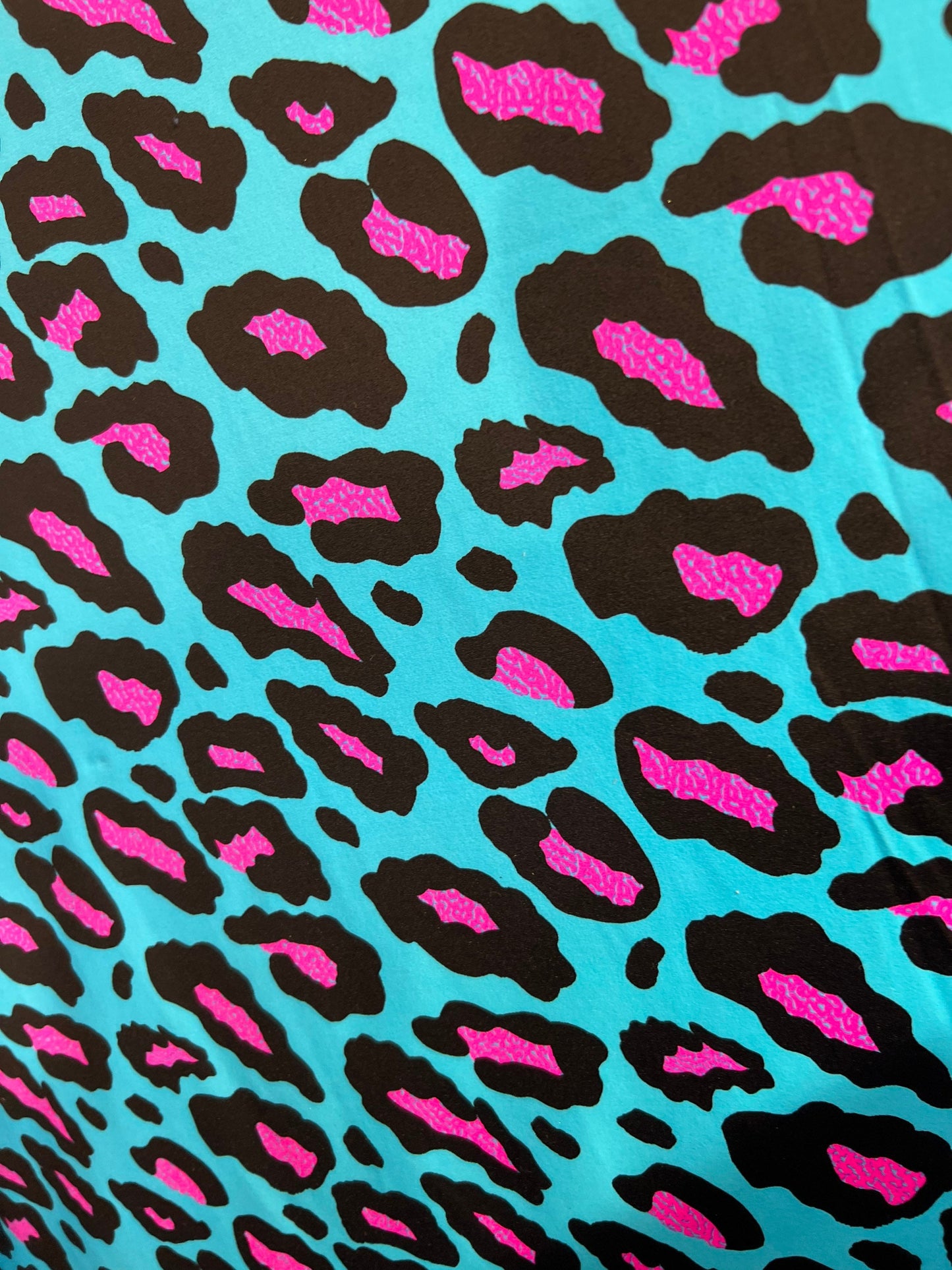 New Exotic Leopard design Turquoise/Pink it glows in the dark with black light 4-way stretch 58/60” Sold by the YD. Ships Worldwide from L.A