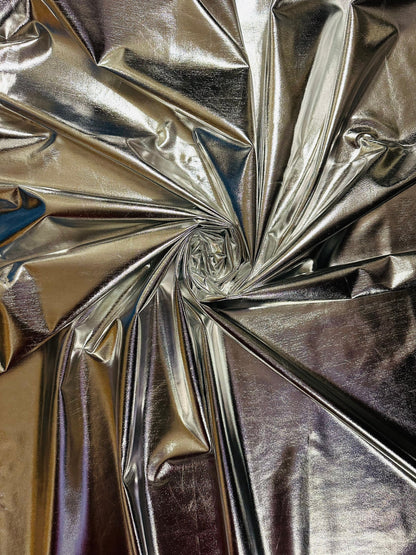 Super shiny all over foiled silver metallic lame poly spandex 4-way stretch 58/60” Sold by the YD. Ships worldwide from Los Ángeles Californ