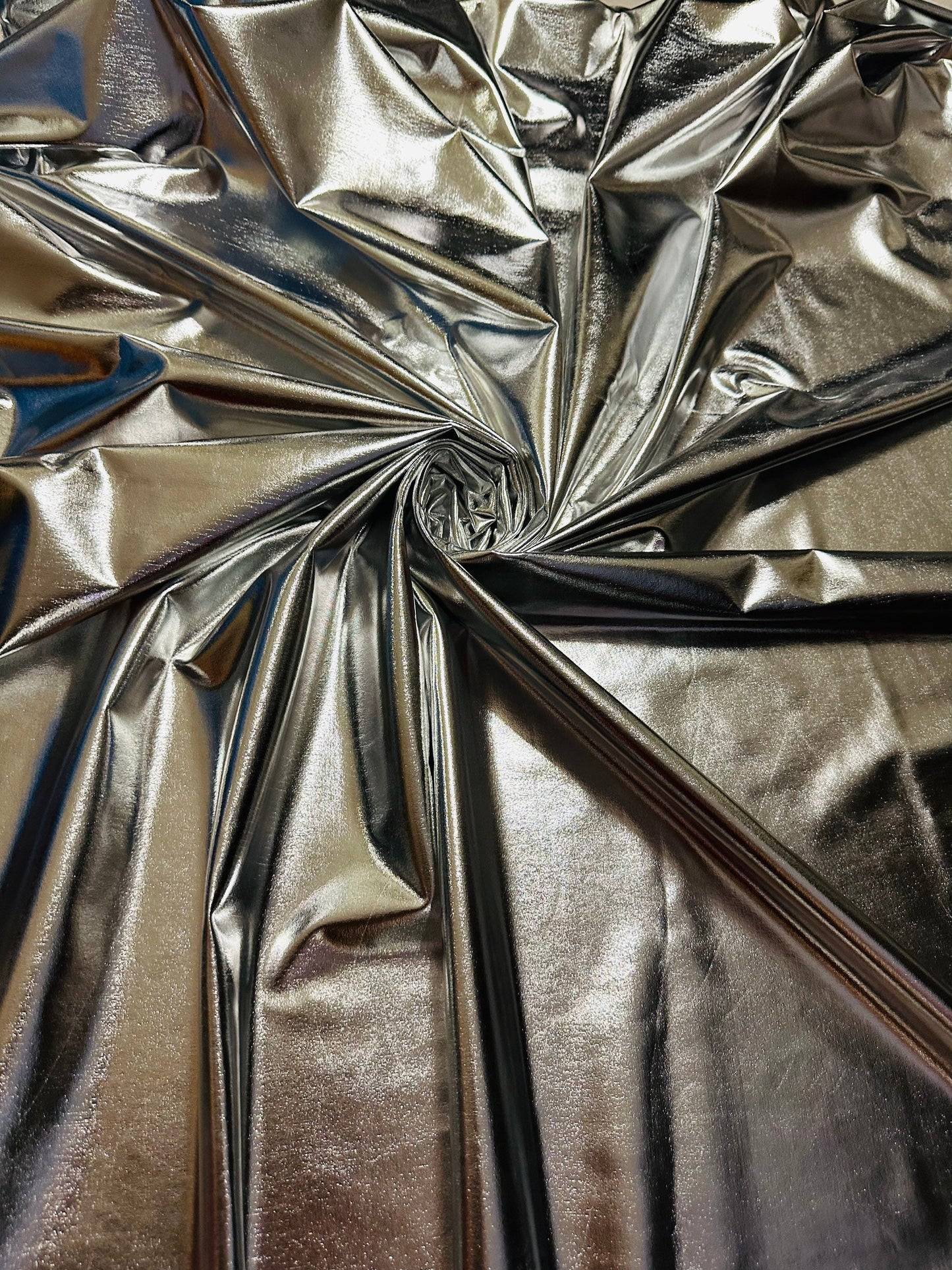 Super shiny all over foiled silver metallic lame poly spandex 4-way stretch 58/60” Sold by the YD. Ships worldwide from Los Ángeles Californ