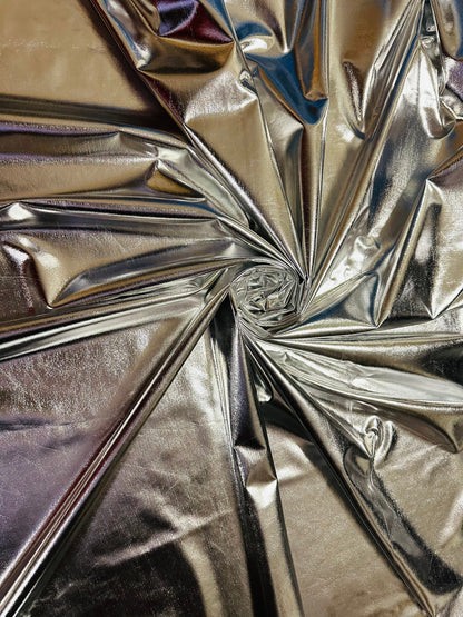 Super shiny all over foiled silver metallic lame poly spandex 4-way stretch 58/60” Sold by the YD. Ships worldwide from Los Ángeles Californ